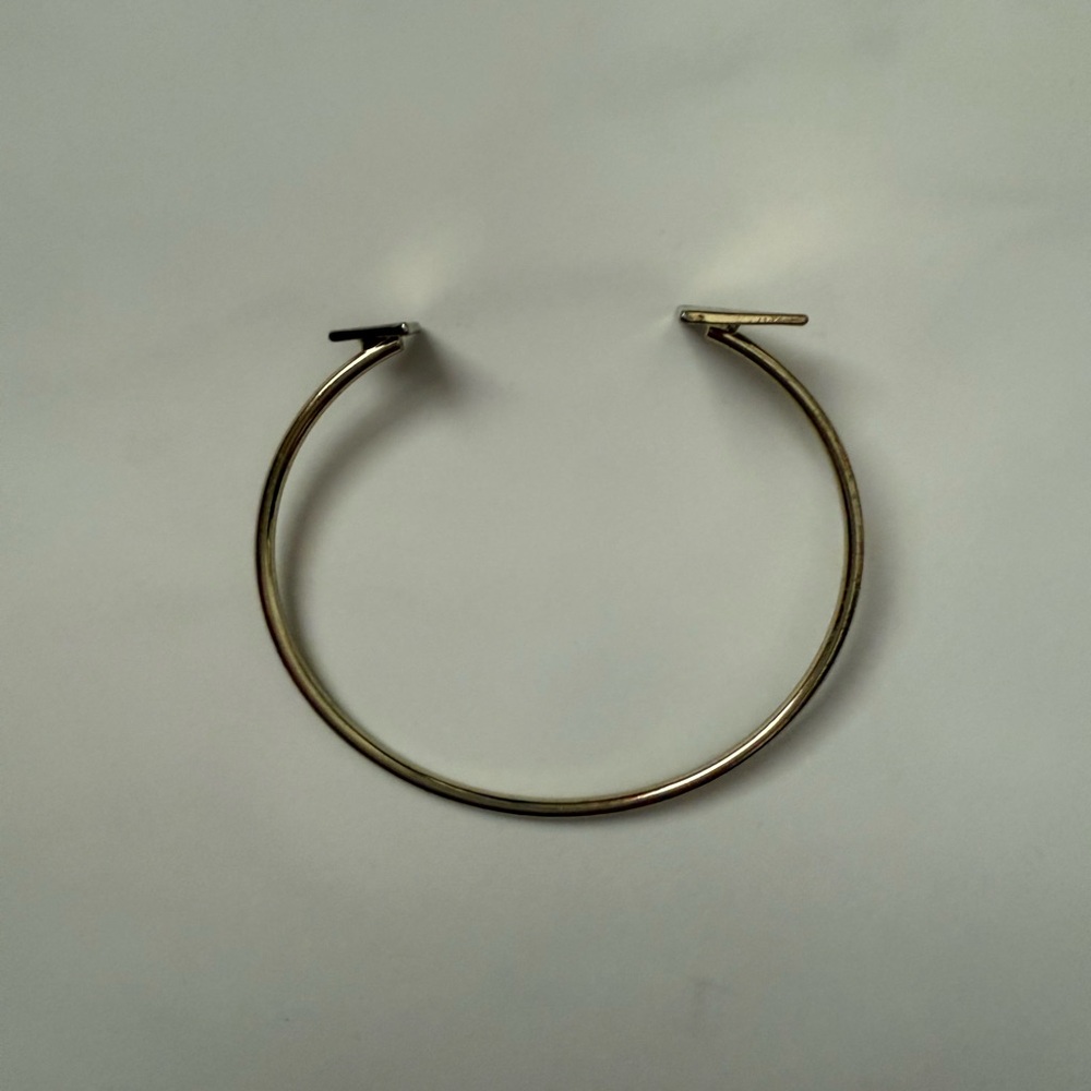 Never Used Gold Hoop Bracelet with triangles on both ends.